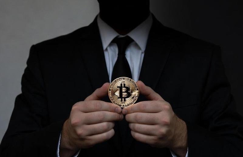 A man holding the Bitcoin.